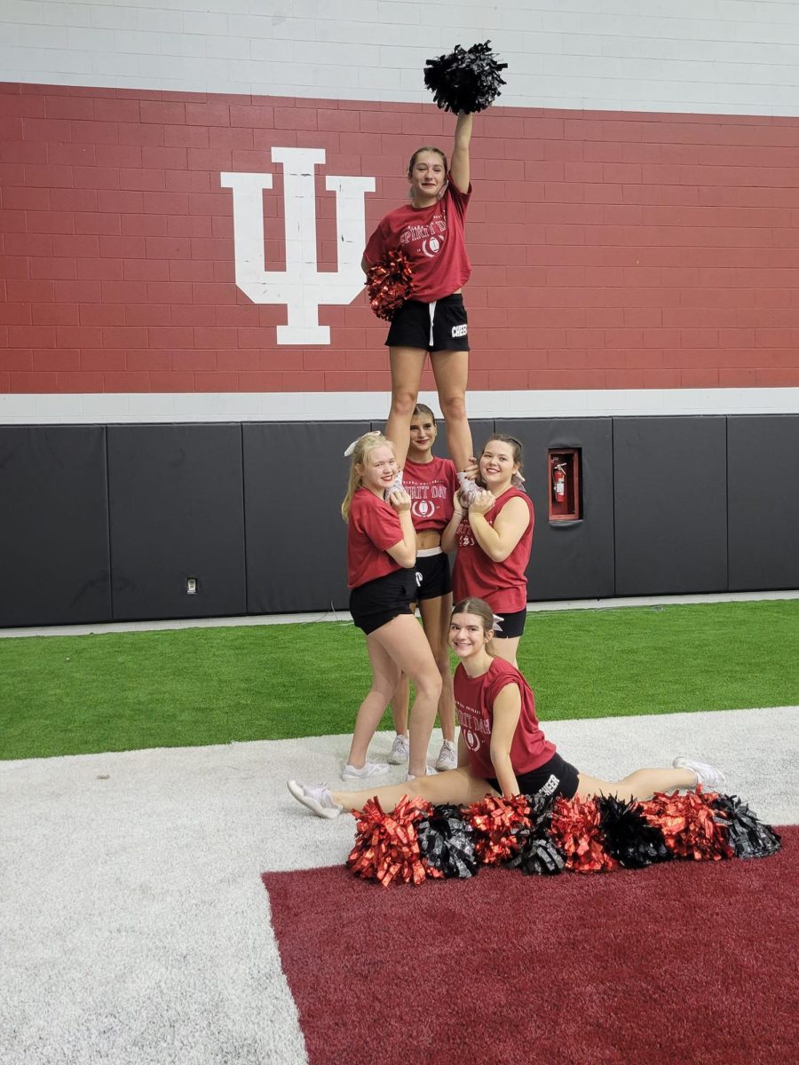 FHS Cheerleaders Jaylin Alexander (flyer), Bella Lofland, Aryanna Pillitiere, Ava Davis, and Bella Mann (front splits) got to cheer at IU during a football halftime show.