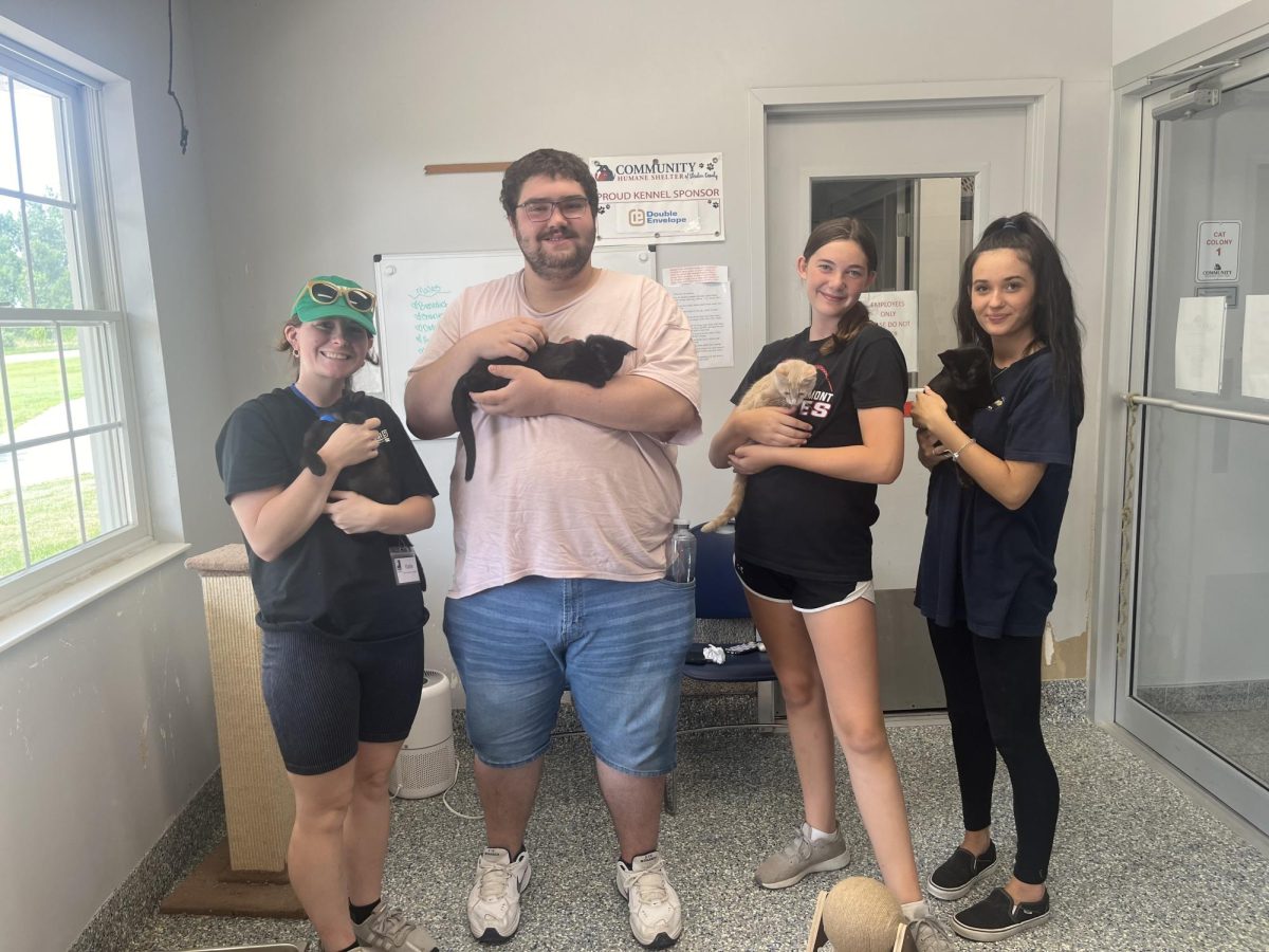 FHS Students Adam Handley (second from left), Rylee Hays, and Jillian Allman spent time over the summer working as summer interns in the community through a post-secondary transitions program.