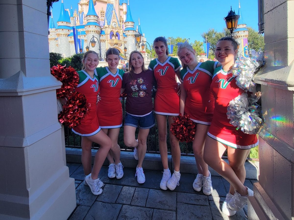 FHS Cheerleaders Jaylin Alexander, Bella Mann, coach Krystal Davis, Aryanna Pilitiere, Bella Lofland and Ava Davis stand in front of Cinderella's Castle at Disney's Magic Kingdom, Orlando. The cheerleaders got to cheer at Disney over Thanksgiving Break.